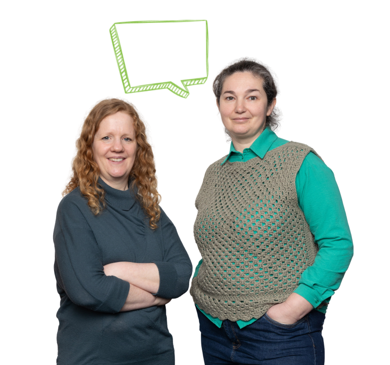 Two women smile at the camera, next to a thought bubble